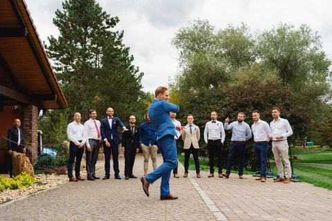 Ženich hází podvazek do davu mužů, svatba Golf resort Kunětická hora