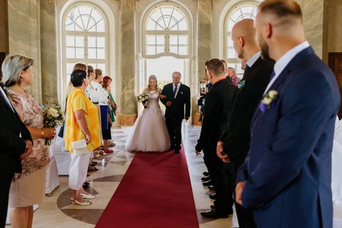 Tatínek vede nevěstu špalírem k místu obřadu, zámek Karlova Koruna